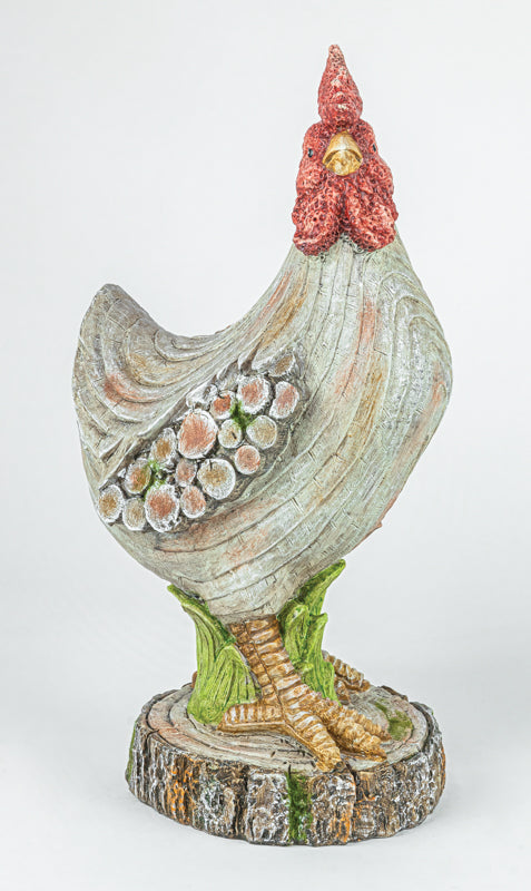 A decorative garden statue of a chicken standing on a faux tree stump base, featuring a textured gray body, red comb, green legs, and pink-and-white patterned tail feathers.