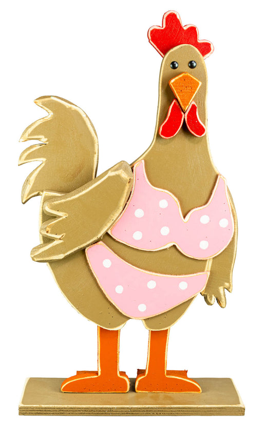 A stylized decorative rooster figurine on a rectangular base. The rooster has a tan body, a red comb and wattle, orange legs and beak, and a pink polka-dot apron.