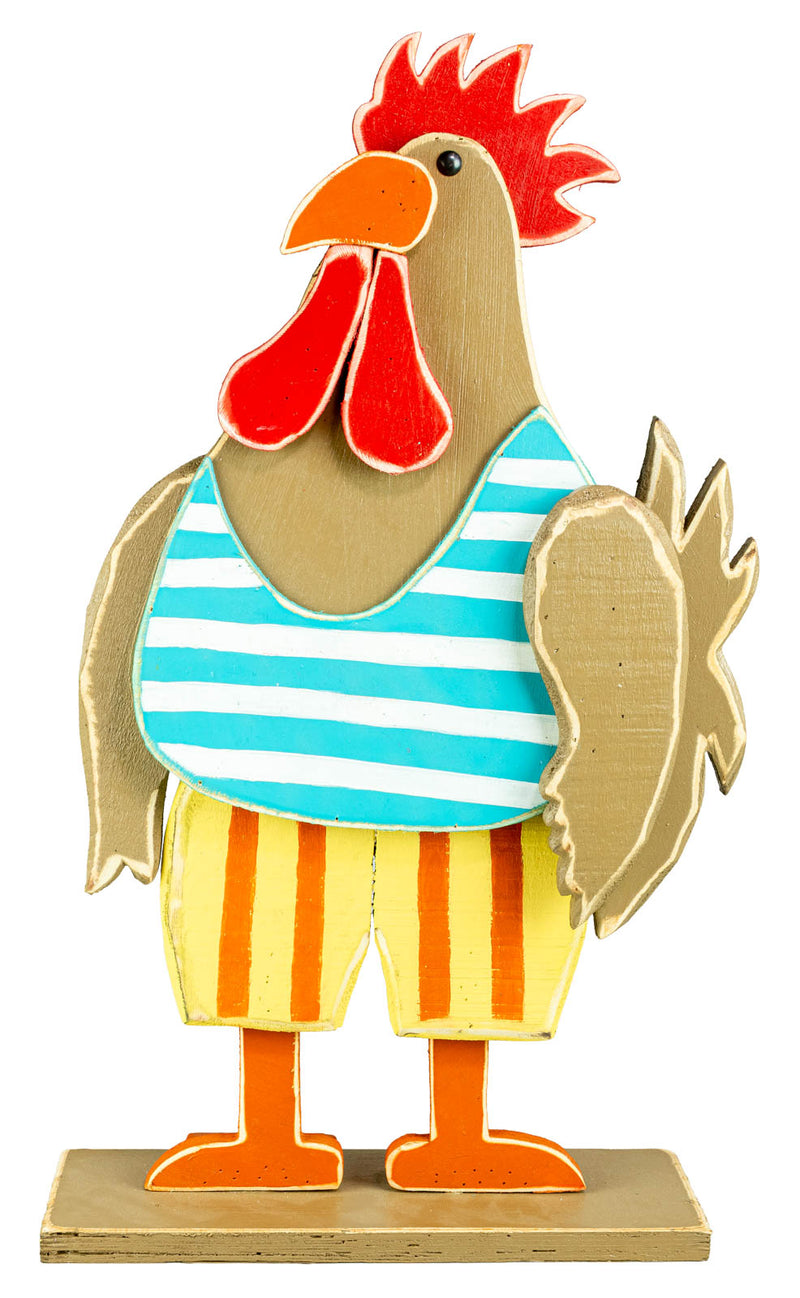 A whimsical wooden rooster figurine wearing a blue and white striped shirt and yellow striped shorts, standing on a small wooden base against a white background.