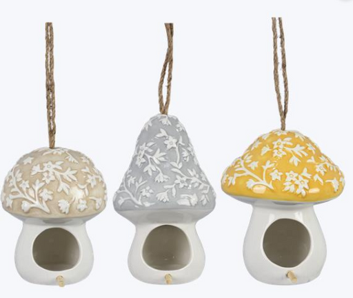 Three decorative mushroom-shaped birdhouses with floral patterns on a white background