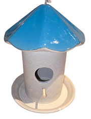 A ceramic mushroom-shaped birdhouse feeder with a green roof and gray base.