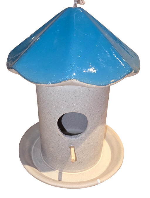 A ceramic mushroom-shaped birdhouse feeder with a green roof and gray base.