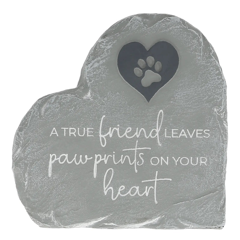 A heart-shaped gray stone memorial plaque with a cutout paw print in a heart shape and the engraved text 'A TRUE friend LEAVES paw prints ON YOUR heart' on a white background.