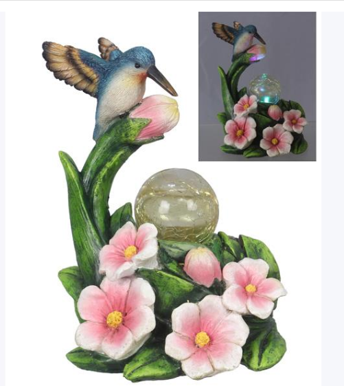 Decorative garden sculpture with a hummingbird, flowers, and a solar light on a white background.