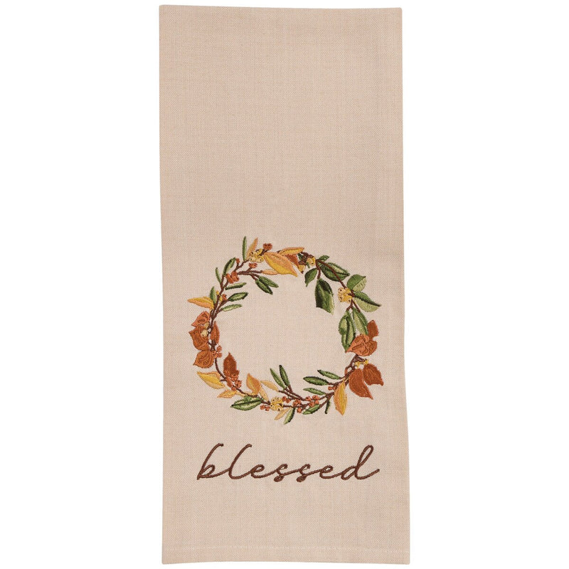 Beige towel with autumn leaf wreath and 'blessed' text on a beige background