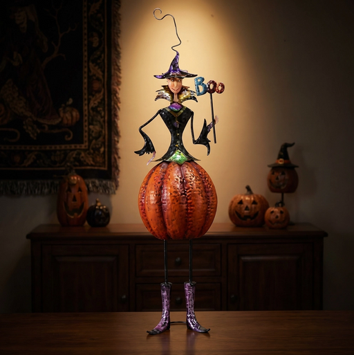 Halloween-themed decorative figure on a pumpkin with 'BOO' text, standing on a wooden surface.