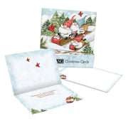 Set of Christmas cards with gnomes in a sleigh design, featuring envelopes and a card holder.