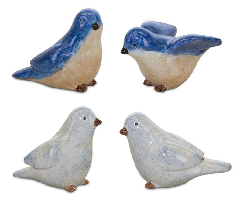 Four ceramic bird figurines with blue and white speckled patterns on a white background