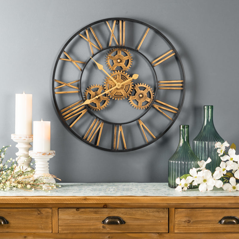 Decorative wall clock with gears on a gray wall above a wooden console table.