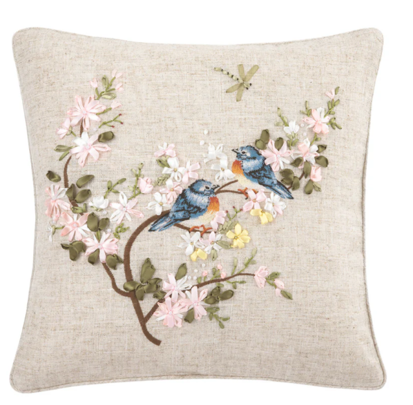 Decorative pillow with embroidered birds and flowers on a beige background