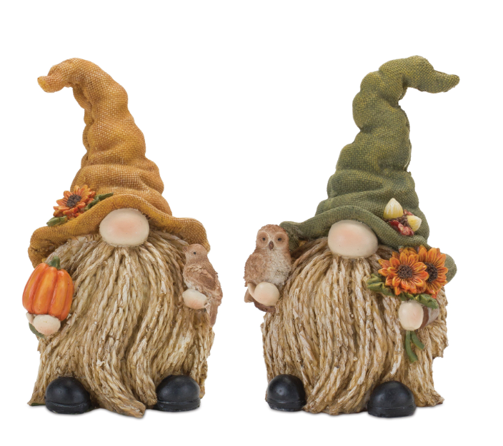 Two decorative gnomes with autumn-themed accessories on a white background