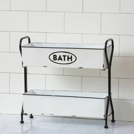 Metal bath tub with 'BATH' label on a tiled bathroom floor