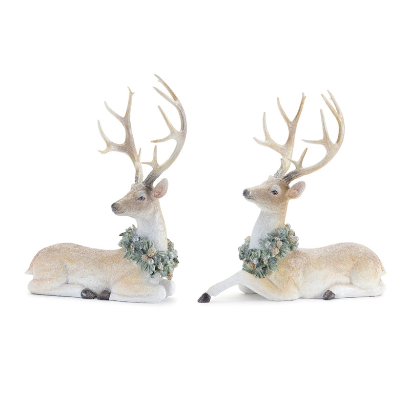 Two deer figurines with antlers and floral wreaths on a white background