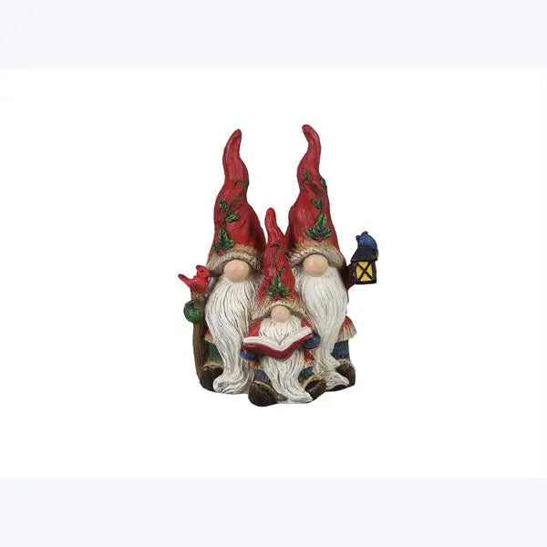 Three gnome figurines with red hats and white beards on a white background