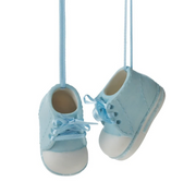 A pair of blue ceramic baby bootie ornaments hanging by strings, against a white background.