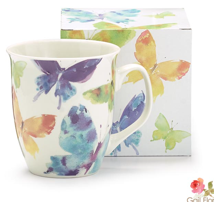 Mug with butterfly design in front of a matching box on a white background