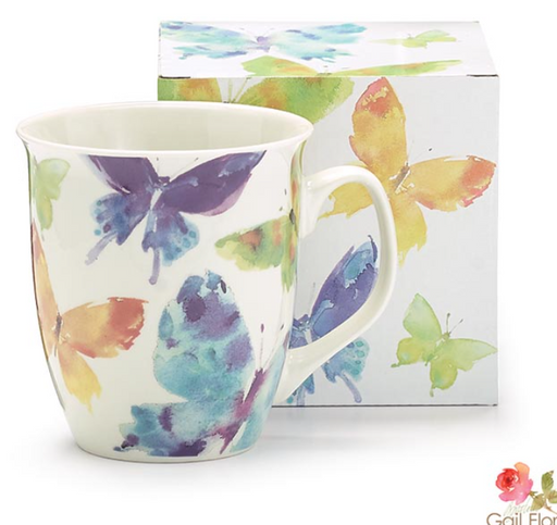 Mug with butterfly design in front of a matching box on a white background