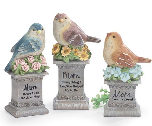 Three decorative bird figurines with floral and text elements on a white background