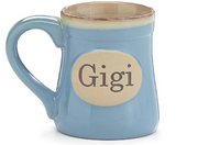 Blue mug with 'Gigi' on a beige label against a white background