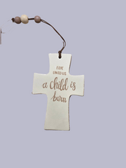 Decorative cross ornament with 'For unto us a child is born' text on a light purple background