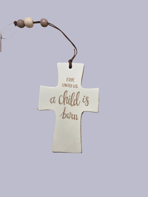 Decorative cross ornament with 'For unto us a child is born' text on a light purple background