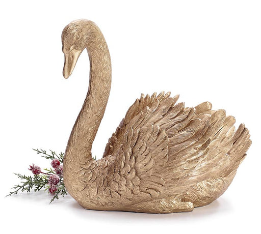 Gold swan sculpture with a branch of flowers on a white background