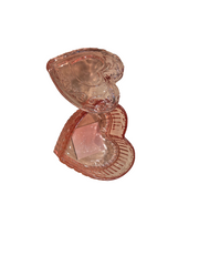 Pink glass candy jar on a white background