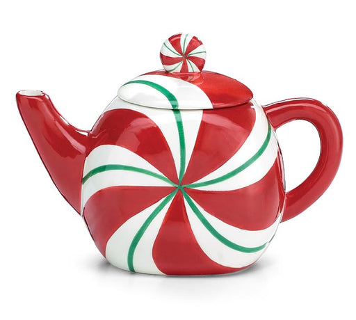 A glossy ceramic teapot designed like a peppermint candy, featuring a red and white swirl pattern with green accent lines, on a plain white background.
