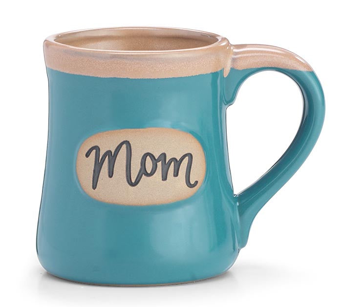 A teal ceramic mug with a beige interior and handle, featuring a beige label on the front with the word 'Mom' in black script.