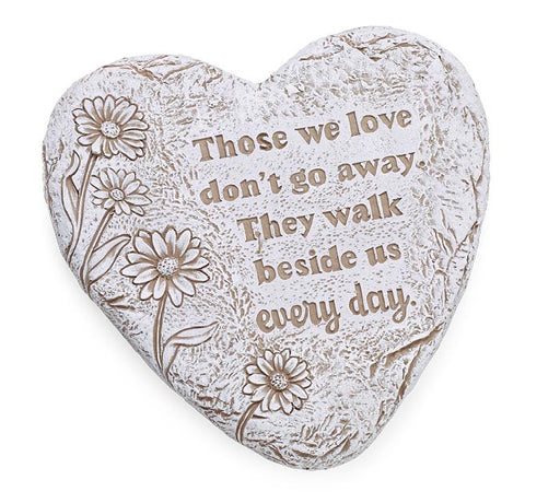 Heart-shaped memorial garden stone with engraved daisy flowers and the quote 'Those we love don't go away. They walk beside us every day.