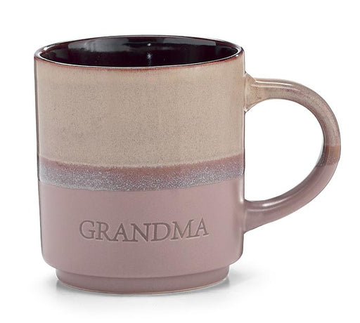 A ceramic mug with a two-tone design, featuring a textured beige top half and a dusty mauve-pink bottom half with the word 'GRANDMA' embossed on the front. The handle and interior are in a matching dusty mauve color.