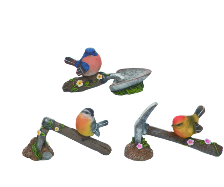 Set of three bird figurines on a white background
