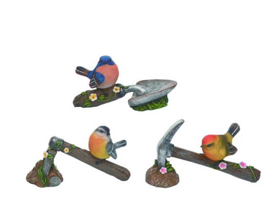 Set of three bird figurines on a white background