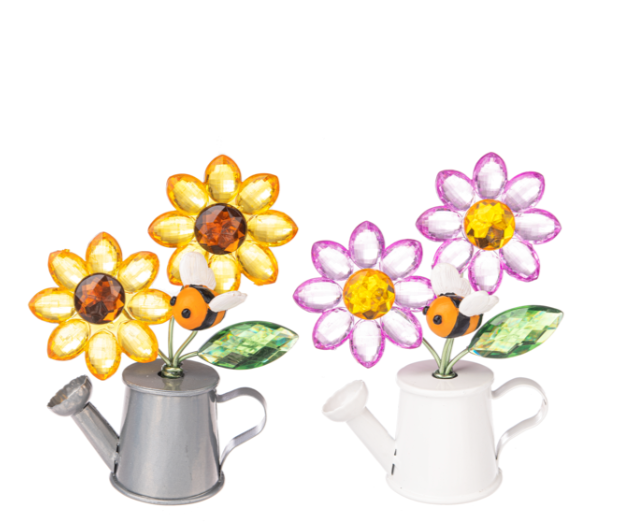 Decorative flower lights with colorful flowers and bees on silver and white watering can bases.