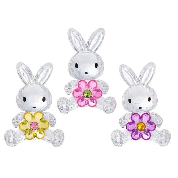 Three clear faceted bunny charms with embroidered black eyes and noses, each holding a flower crystal: yellow with pink center on the left, pink with green center in the middle, and purple with yellow center on the right, shown on a white background.