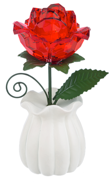 A decorative red faceted glass rose with green leaves and a black metal scroll stem, set in a white ribbed ceramic pot against a plain white background.