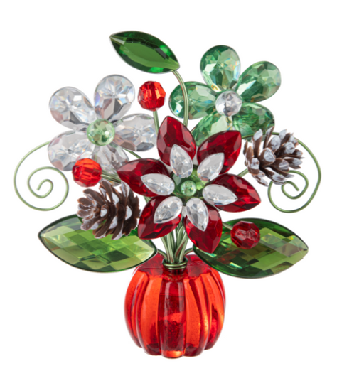 Decorative flower arrangement with red, green, and clear flowers in a red vase on a white background