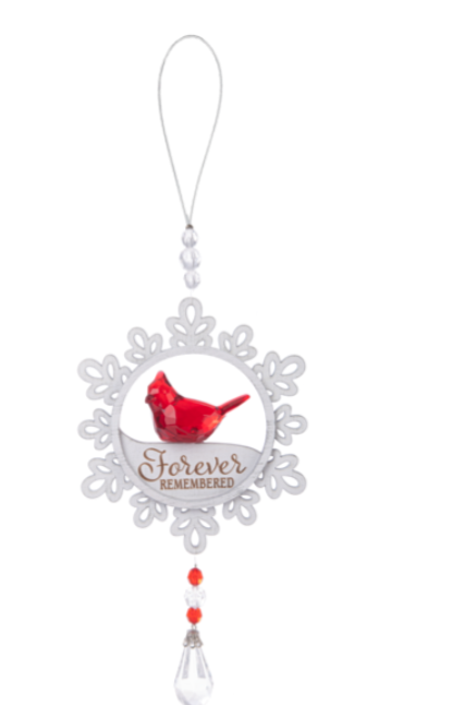 Decorative ornament with a red bird illustration and 'Forever Remembered' text on a white background