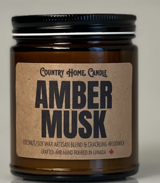 Amber Musk candle in a glass jar with a brown label on a white background