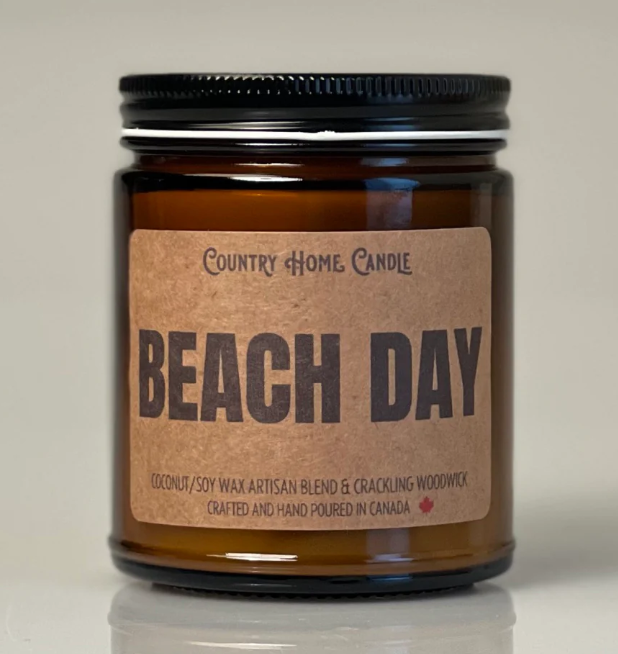 Candle jar labeled 'Beach Day' by Country Home Candle on a neutral background