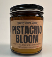 Candle jar labeled 'Pistachio Bloom' by Country Home Candle on a light background