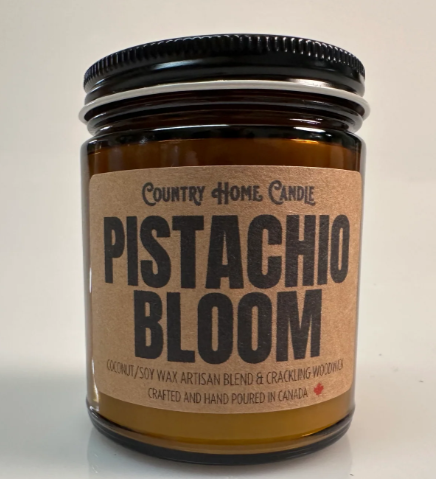 Candle jar labeled 'Pistachio Bloom' by Country Home Candle on a light background