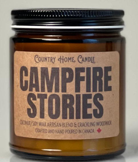 Jar of 'Campfire Stories' candle with a label on a neutral background