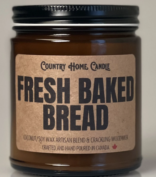 Jar of 'Fresh Baked Bread' candle with a brown label on a neutral background