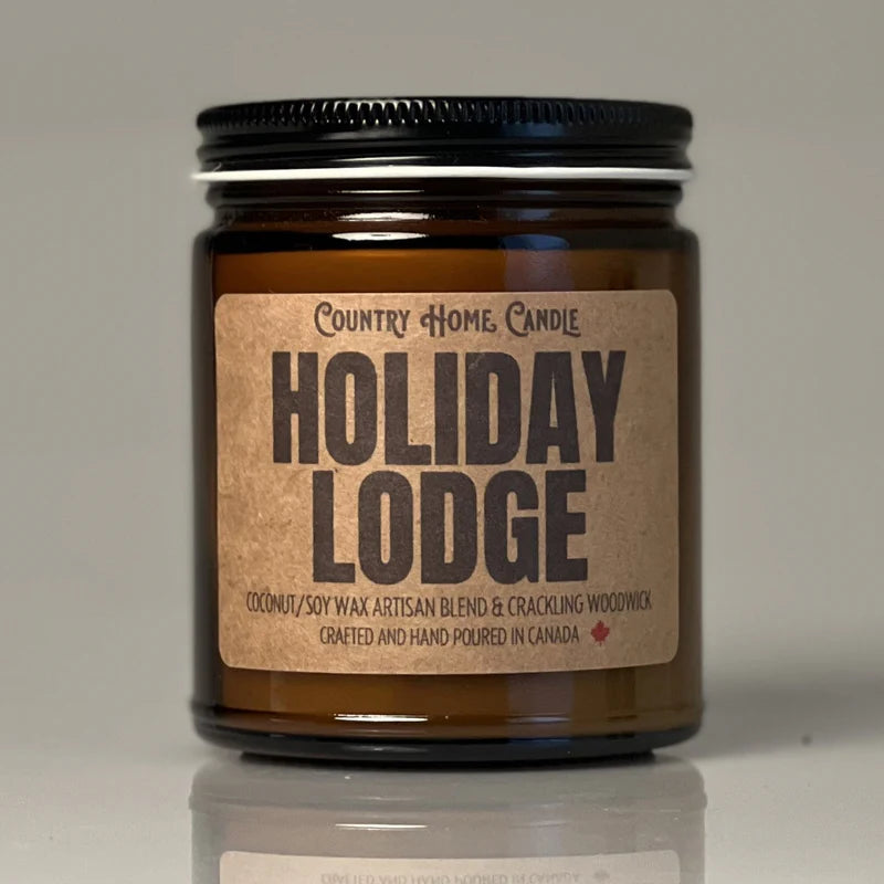 Candle jar labeled 'Holiday Lodge' with a brown label on a neutral background