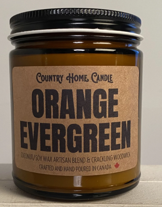 Candle jar labeled 'Orange Evergreen' by Country Home Candle on a neutral background