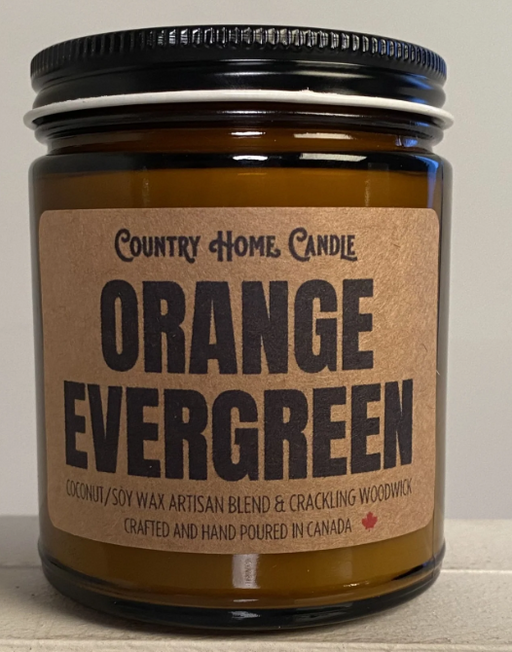 Candle jar labeled 'Orange Evergreen' by Country Home Candle on a neutral background