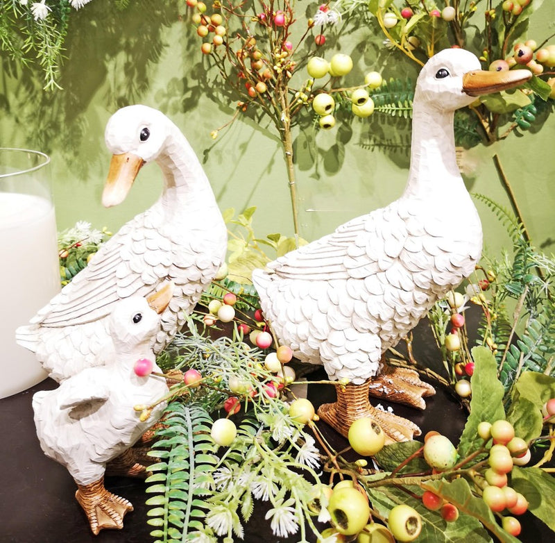 Decorative goose statues with a green background