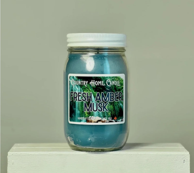 Jar of 'Fresh Amber Musk' candle by Country Home Candle on a neutral background