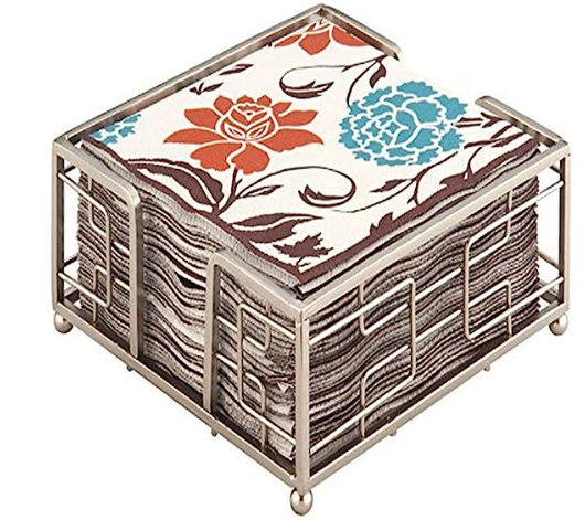 Decorative coaster set with floral design in a metal holder on a white background